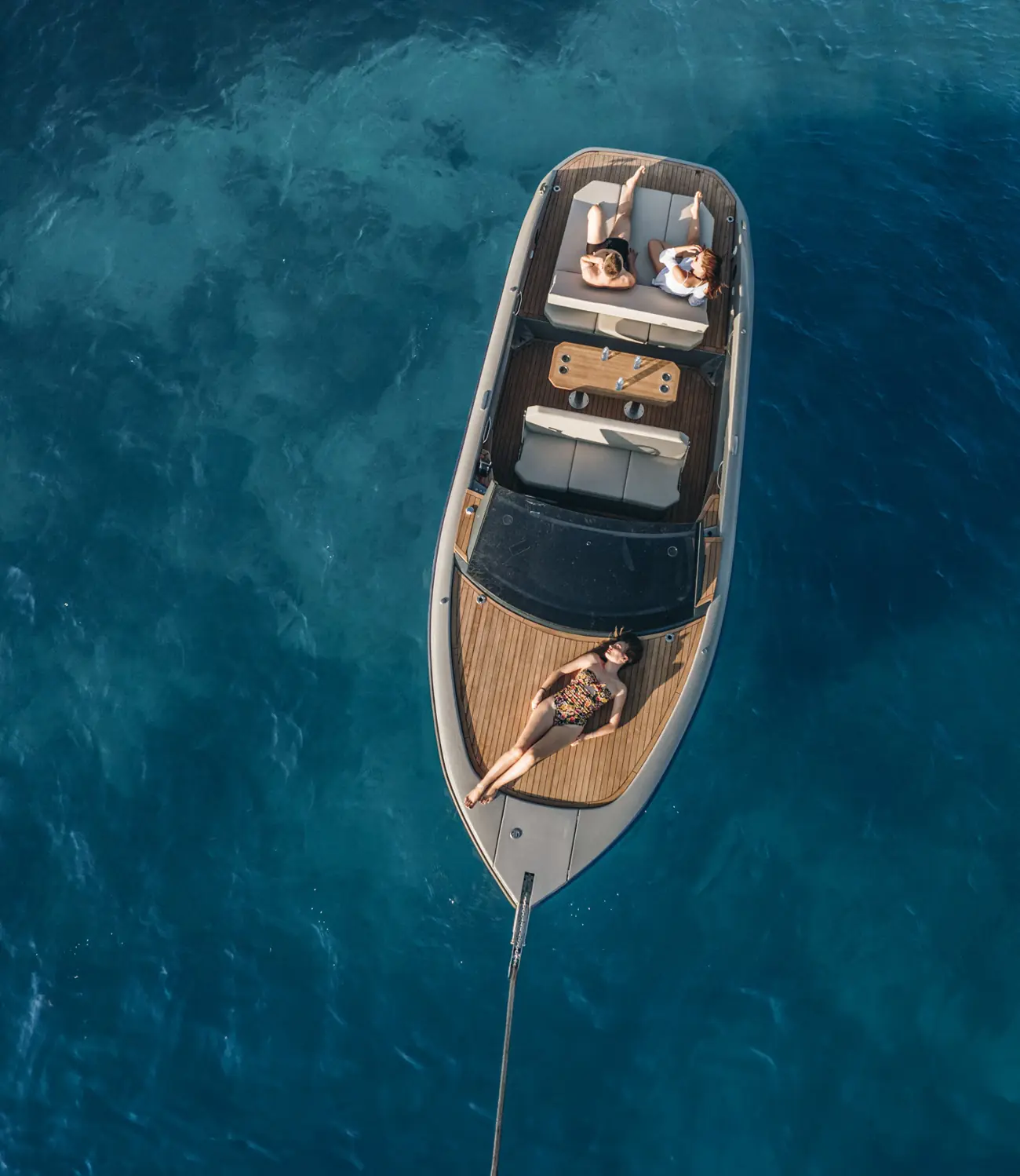 Aerial view of a RAND at anchor with guests on the foredeck