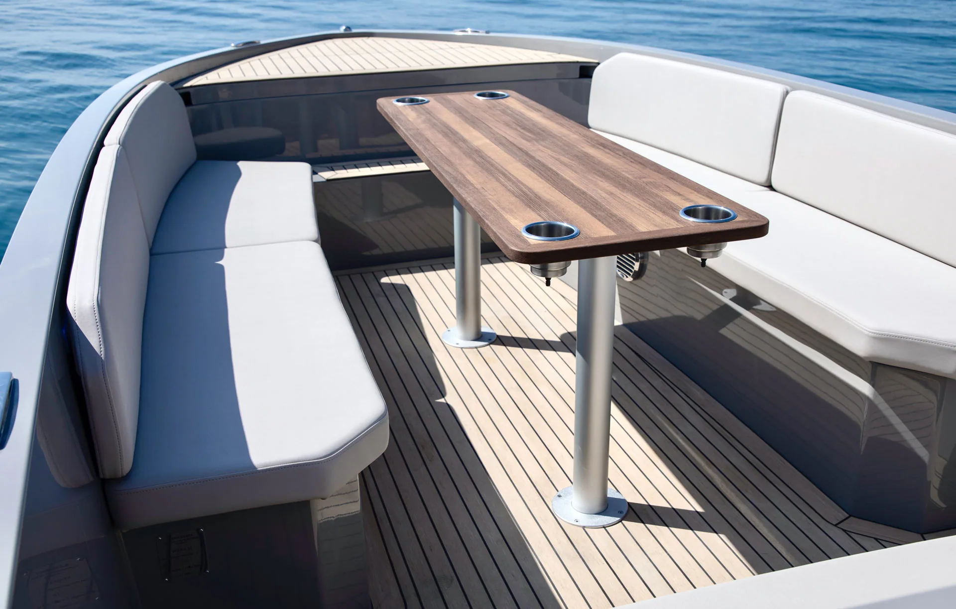 Teak table and wraparound seating aboard Serene 24